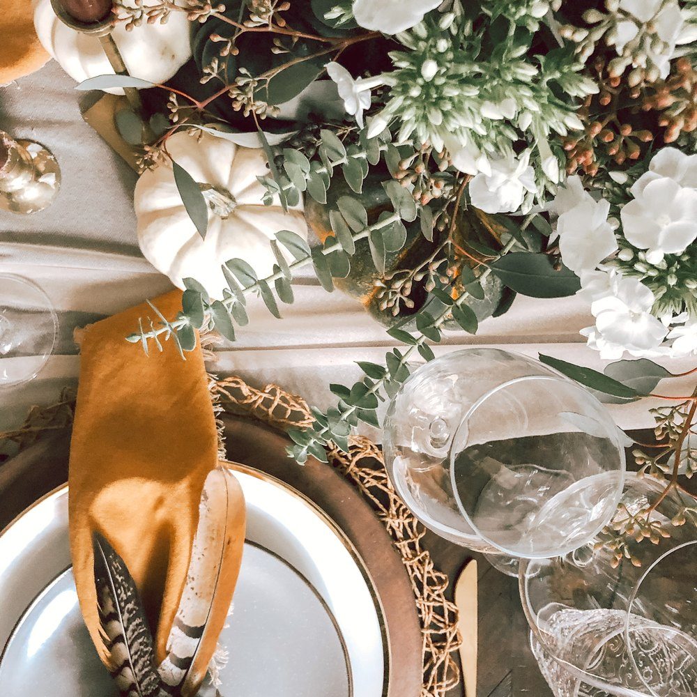 A table set with linen, florals and glassware for an intimate gathering